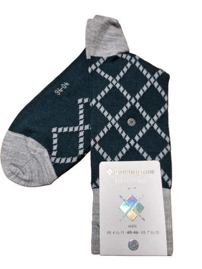 A single knit sock laid on a wooden surface, shown with its retail tag. The sock has a dark teal body with a white argyle diamond pattern and light gray cuffs, heels, and toes.