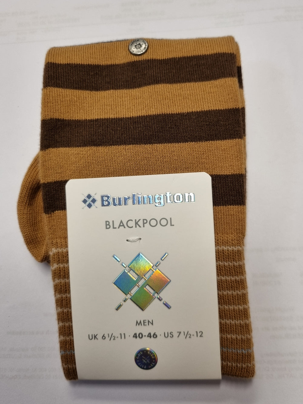 A pair of Burlington Blackpool men's socks with brown and mustard yellow horizontal stripes, folded with a white paper brand tag attached.