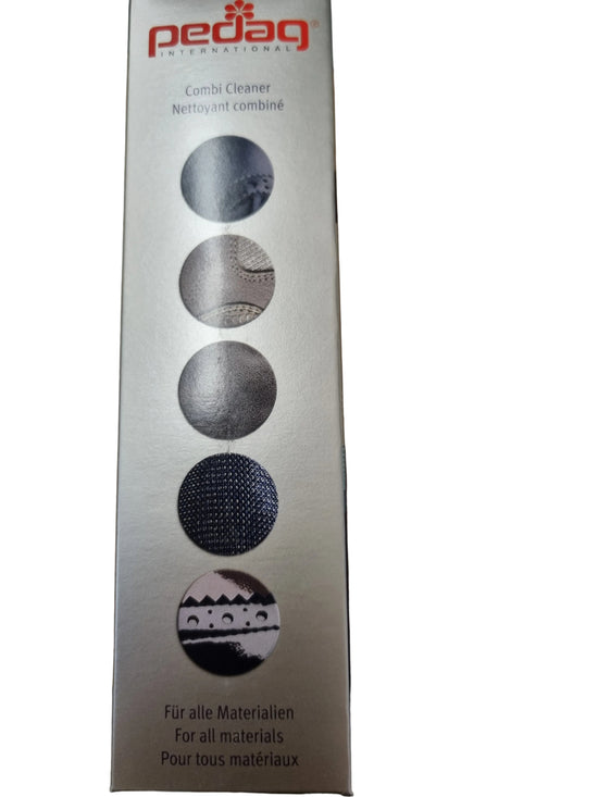 A tall rectangular Pedag Combi Cleaner box standing on a wooden tabletop. The packaging is metallic silver with red Pedag branding at the top and five circular material-use icons printed vertically in dark gray and black.